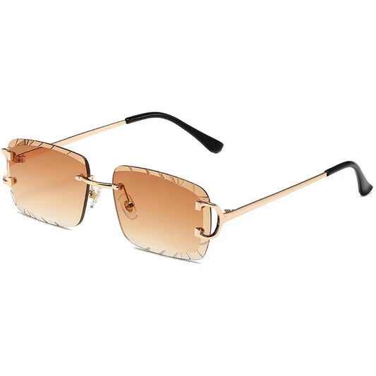 Vintage gold rimless sunglasses with amber gradient engraved lenses and slim metal arms – Solar Muse collection.