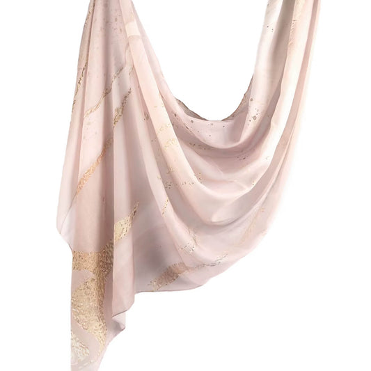 Light pink chiffon hijab with subtle gold marbled patterns, draped in soft folds – Guavablush Luxe Chiffon Hijab.