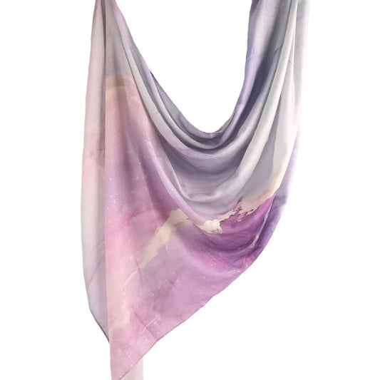 Cotton-modal hijab in a soft marbled pattern named Lunara, featuring dreamy lilac, blush pink, and pale grey tones inspired by tropical twilight skies.
