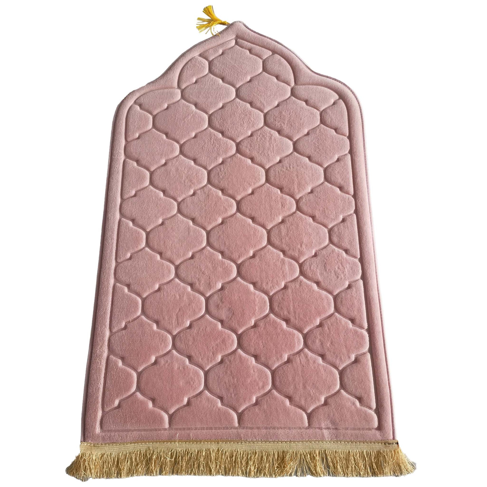 Blush rose prayer mat with geometric quilted pattern and gold tassel trim, shaped in a traditional arched silhouette.